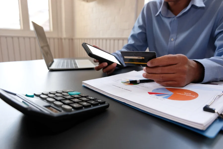 buyer step 01 budget Working through a home budget with a calculator and phone