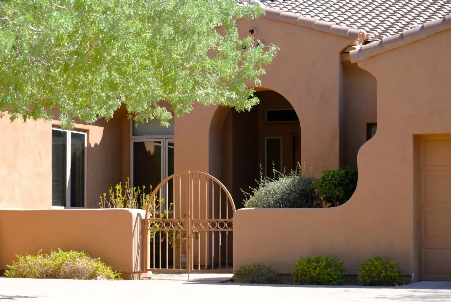 buyer step 07 courtyard Stucco home with an arched courtyard gate