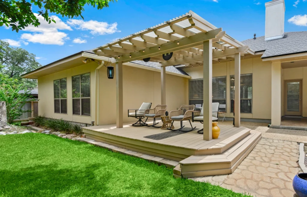 Home Value Hero pic 1 Single-story home with a covered pergola deck and a green lawn