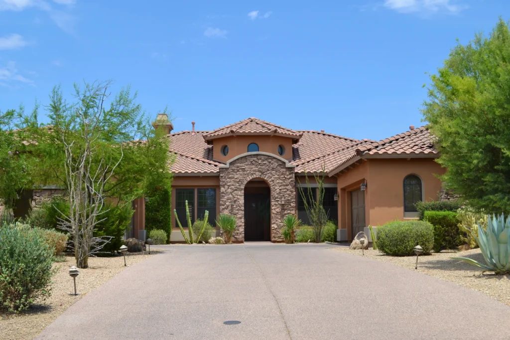 Luxury home with a stone entry and desert landscaping