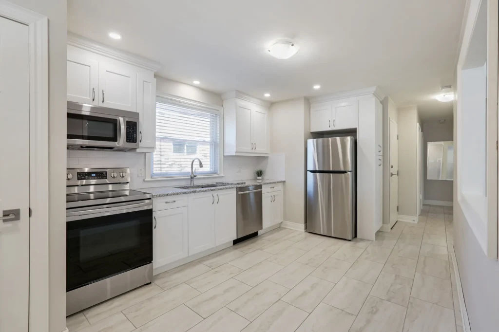 Updated kitchen with white cabinets and stainless appliances