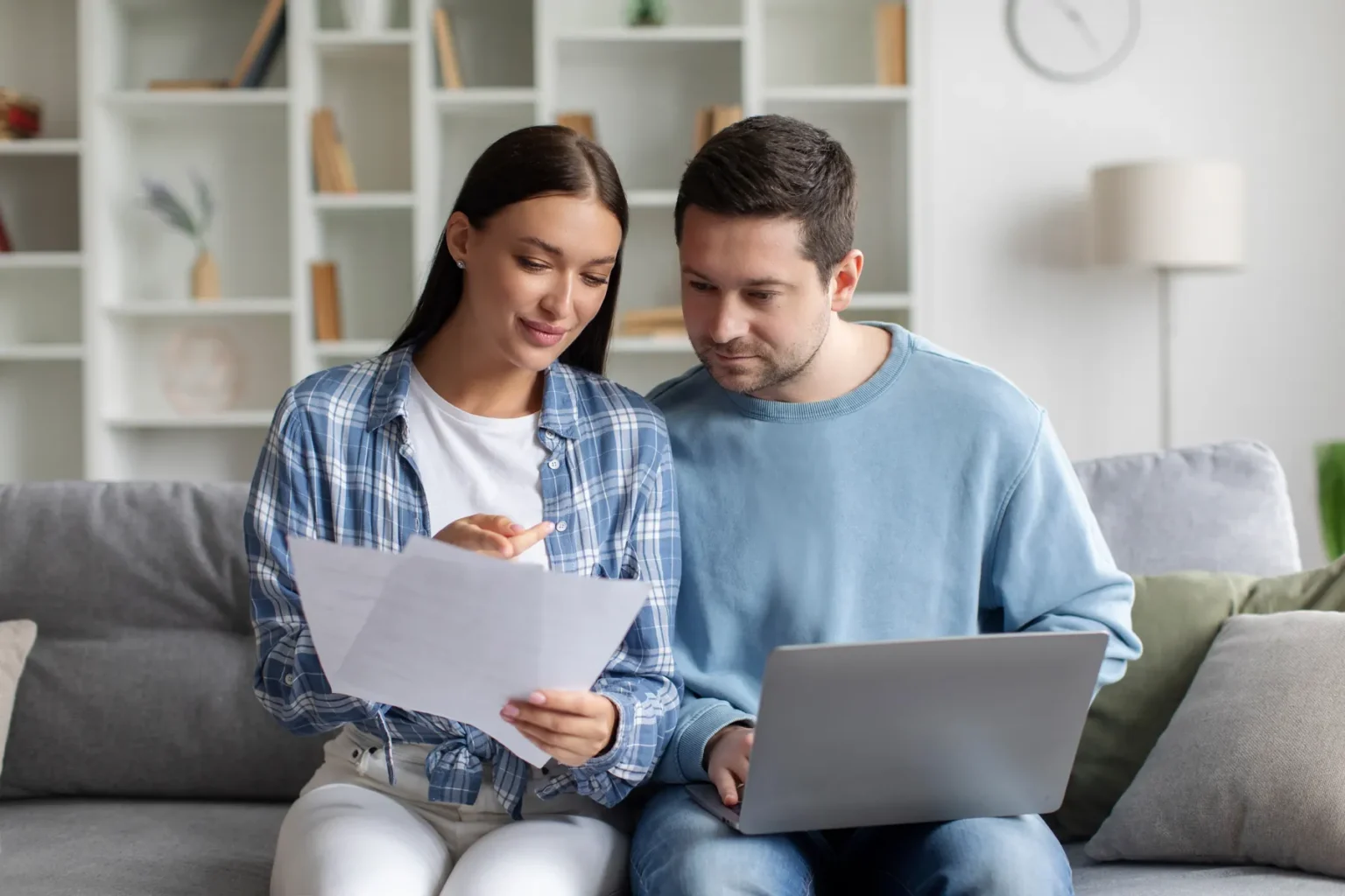 seller step 06 paperwork Couple reviewing paperwork and a laptop at home